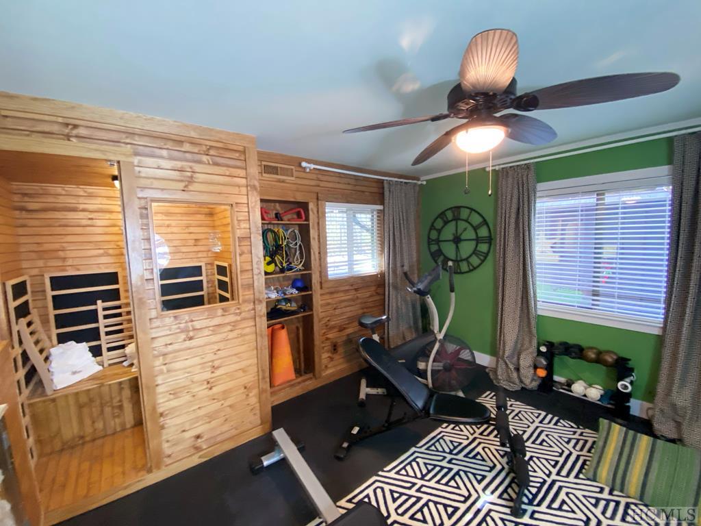 Exercise room with sauna and steam room and bath